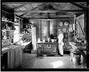 Asian cook at wood stove, cookhouse interior, 9/26/1935, #14219_1