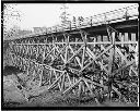 Three people on wooden trestle, circa 1940, #15093_1