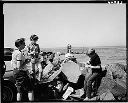 Woman and children picnicking on breakwater, 8/24/64, #46883_1