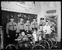 Police officers with winners of bikes, 12/18/65, #49429_1