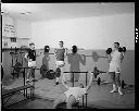 Four young men lifting weights at YMCA, 1/27/66, #49609_1