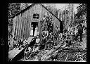 Logging camp cookhouse with women in doorway and loggers posed outside, circa 1905, #4495_1