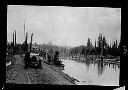 Ellison log boom with man and Chalmers car, circa 1915, #4531_1