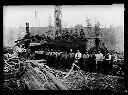 Group of loggers with log marked 