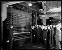 Group of men viewing plywood press, 12/14/1934, #13715_1