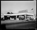 Jensen Service Station exterior with three attendants, Wishkah & Park Sts, 7/1937, #15020_1