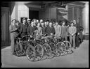 Bicycles and group of men at Hotel Morck marquee, 2/24/1938, #15446_1