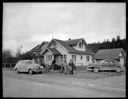 Native American home exterior with family and cars at Taholah, 1/27/1942, #19109_1