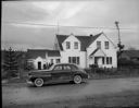 Native American home exterior with car at Taholah, 1/27/1942, #19111_1