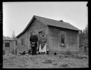 Native American couple in front of their winter home on the Queets River, 1/30/1942, #19117_1