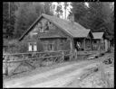 Unidentified Native American woman and child on porch of house in Queets, 1/30/1942, #19123_1