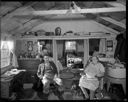 Native American home interior with couple and dog at Taholah, 1/27/1942, #19108_1