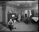 Native American home interior with family and toy car at Taholah, 1/27/1942, #19110_1