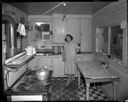 Native American woman in kitchen of home at Taholah, 1/27/1942, #19116_1