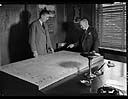  John J. Long and E.W. Daniels inspect plywood in office, 11/4/1938, #16023_1