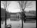 Woman at door of house in flood waters, Westport Highway, 11/23/1959, #35435_1