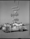 Ocean Shores Resort personnel with convertible and sign, 6/12/1960, #36991_1