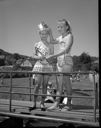 Two girls in bathing suits with pageant crown, 7/14/1960, #37178_1