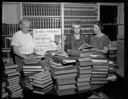 A. A. U. W. book sale, three women examining books, 10/18/1960, #37949_1