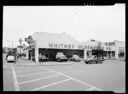 Whitney Oldsmobile Co. exterior with trucks, 7/12/1952, #26726_1