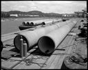 Concrete pipe on dock & barge, 7/21/1956, #31278_1