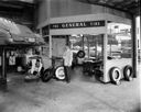 Putting new tires on car at Whitney Oldsmobile , 9/6/1951, #26228_1