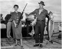 Westport Fish Derby, couple with gun, fish, and motor , 8/15 /1953- 8/16/1953, #27532_1