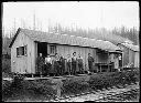 Group of men in front of logging camp building, 3/29/1905, #G0069_1