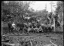 Group of loggers with crosscut saw by railroad tracks , 3/29/1905, #G0084_1