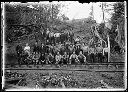 Group of loggers with crosscut saw by railroad tracks , 3/29/1905, #G0085_1