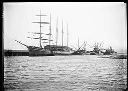 Masted ship and other vessels at dock, circa 1922, #G0162_1