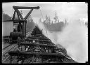 Unloading logs from railroad carriage, circa 1910, #G0499_1