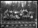 Group portrait of loggers by railroad tracks, circa 1922, #G0556_1