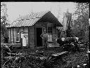 Couple outside with cow and cat, circa 1920, #G0668_1