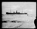 Ship TENPAISAN MARU aground, crewman coming ashore in breeches buoy, 11/24/1927, #G1013_1