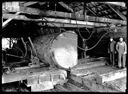 Sawmill interior with big log and two workers, circa 1922, #G1247_1