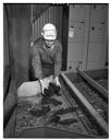 Rayonier plant worker with conveyor and wood chips, 11/1967, #53039_1