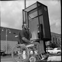 George Caldwell and phone booth with wheel chair accessibility, 5/27/1976, #62988_1