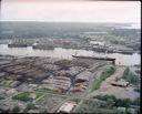 Aerial view of Roderick Timber lumber yard and dock, 6/11/1980, #66309_1