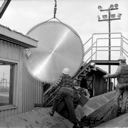 Lifting saw blade with crane at ITT Rayonier, for Rayonier annual report, 10/1983, #68500_1