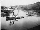 Tug PETREL towing two log rafts near E. K.Wood Mill, 3/7/1926, #L400515_1