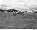 Aircraft and man at a rural grass airstrip, 7/4/1948, #L31R6F33_1