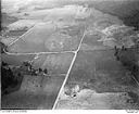 Unidentified farms, fields and roads in a valley surrounded by forested hills, 8/9/1948, #L31R9F3_1