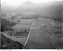 Unidentified farms, fields and roads in a valley surrounded by forested hills, 8/9/1948, #L31R9F5_1