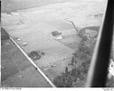 Unidentified farms, fields and roads in a valley surrounded by forested hills, 8/9/1948, #L31R9F6_1