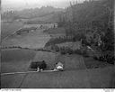 Unidentified farms, fields and roads in a valley surrounded by forested hills, 8/9/1948, #L31R9F7_1