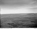 Unidentified timber lands with signs of logging activity and distant mountains, circa 1949, #L32R24F4_1